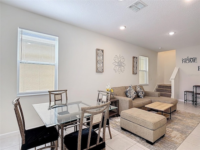 129 Boydfield Ln, Davenport, FL 33837 - dining space featuring light tile patterned floors, stairway, healthy amount of natural light, recessed lighting, and a textured ceiling