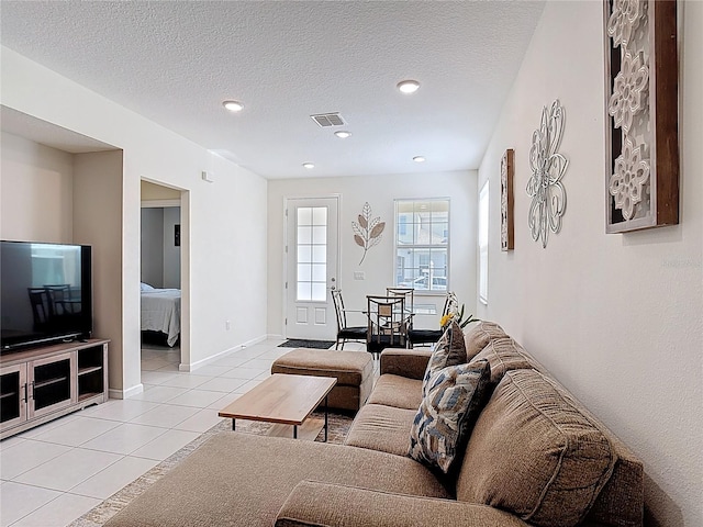 129 Boydfield Ln, Davenport, FL 33837 - living area featuring light tile patterned flooring, a textured ceiling, and recessed lighting