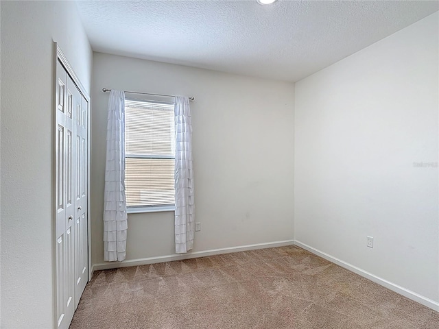 129 Boydfield Ln, Davenport, FL 33837 - unfurnished bedroom with carpet floors, a closet, and a textured ceiling