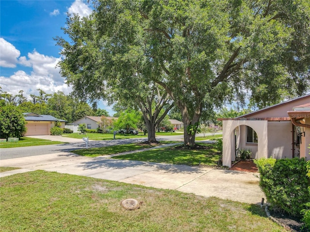 8346 Mattituck Cir, Orlando, FL 32829 - view of green lawn with driveway and a garage