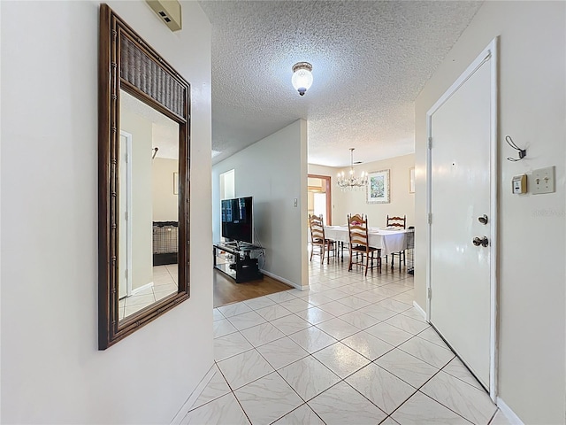 8346 Mattituck Cir, Orlando, FL 32829 - hallway with a chandelier and a textured ceiling