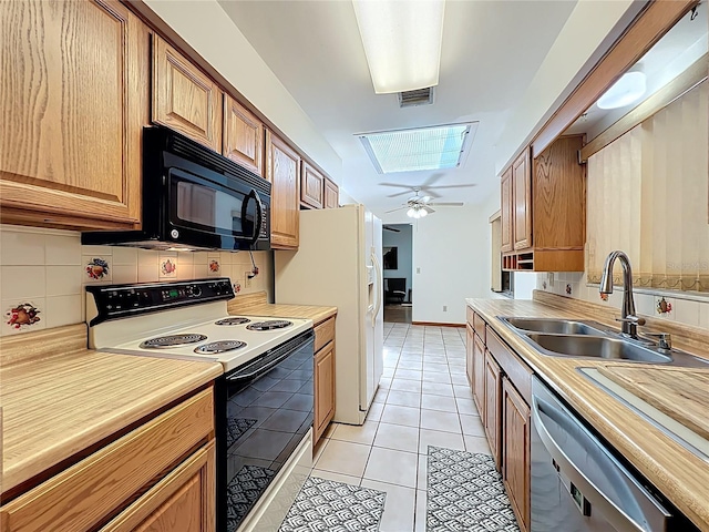 8346 Mattituck Cir, Orlando, FL 32829 - kitchen featuring electric range, black microwave, stainless steel dishwasher, a skylight, and decorative backsplash