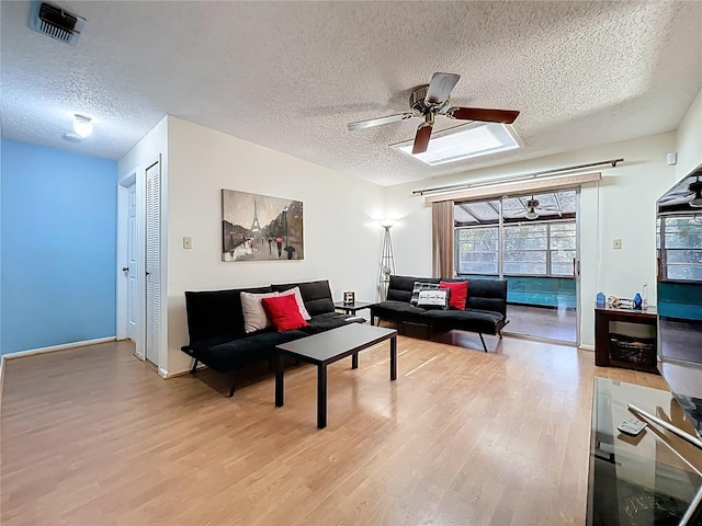 8346 Mattituck Cir, Orlando, FL 32829 - living room with a textured ceiling, wood finished floors, and ceiling fan