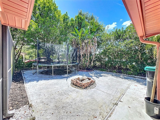 8346 Mattituck Cir, Orlando, FL 32829 - view of patio with a trampoline and a fire pit