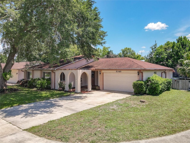 8346 Mattituck Cir, Orlando, FL 32829 - view of front facade with stucco siding, a garage, and driveway