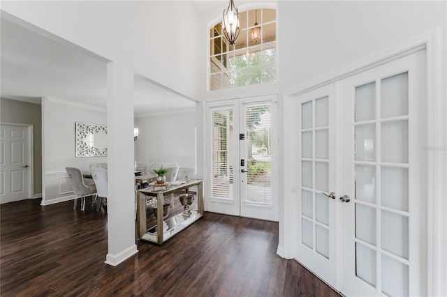 9285 Wickham Way, Orlando, FL 32836 - foyer entrance featuring french doors, a chandelier, dark wood-type flooring, a towering ceiling, and ornamental molding