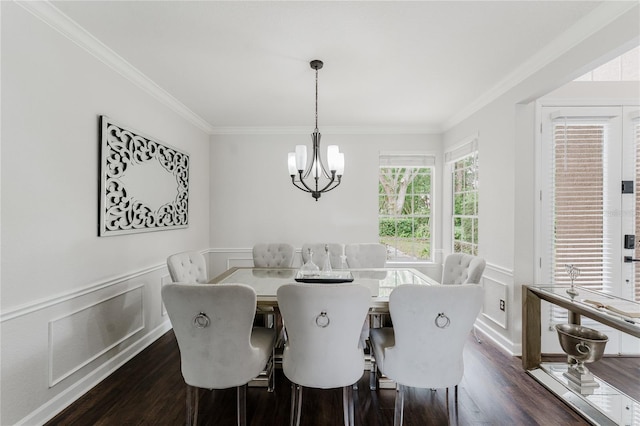 9285 Wickham Way, Orlando, FL 32836 - dining space with ornamental molding, a chandelier, dark wood-style flooring, wainscoting, and a decorative wall