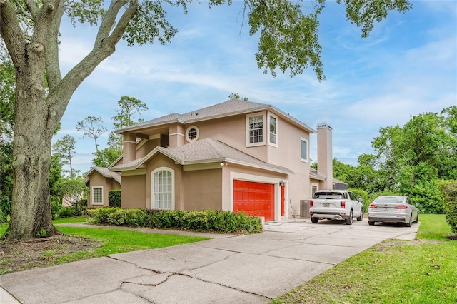 9285 Wickham Way, Orlando, FL 32836 - view of front of property featuring stucco siding, an attached garage, a front lawn, and concrete driveway