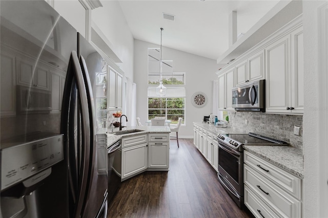 9285 Wickham Way, Orlando, FL 32836 - kitchen with appliances with stainless steel finishes, dark wood-type flooring, decorative backsplash, white cabinetry, and light stone countertops