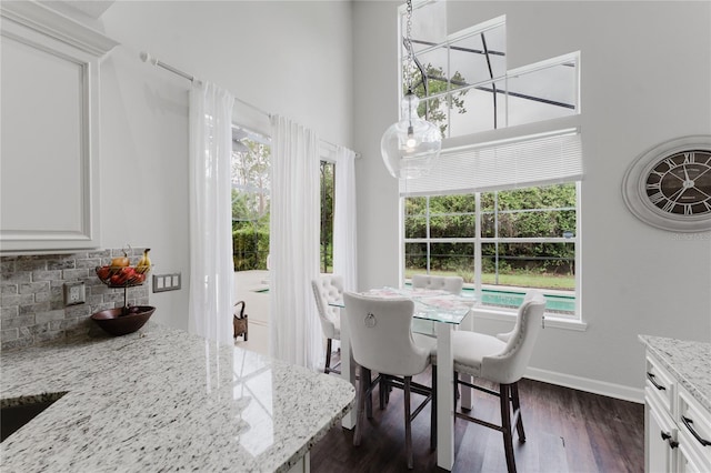9285 Wickham Way, Orlando, FL 32836 - dining area featuring healthy amount of natural light, dark wood-style floors, and a towering ceiling