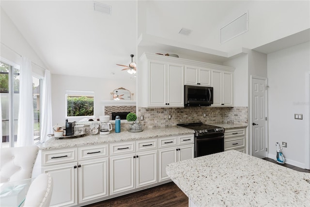 9285 Wickham Way, Orlando, FL 32836 - kitchen with black appliances, dark wood-type flooring, ceiling fan, backsplash, and white cabinetry