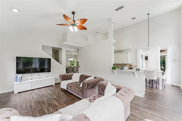 9285 Wickham Way, Orlando, FL 32836 - living area featuring high vaulted ceiling, wood finished floors, ceiling fan, and a chandelier