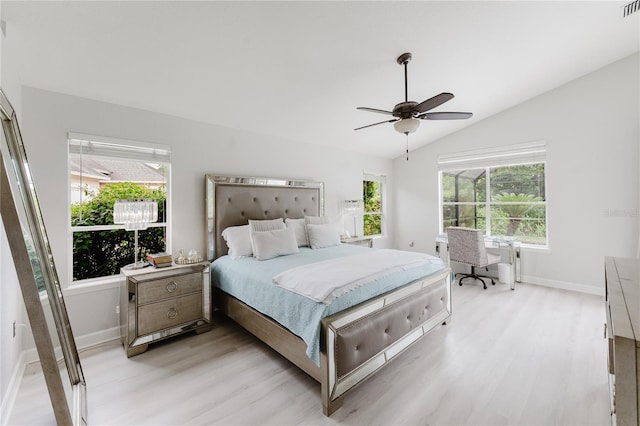 9285 Wickham Way, Orlando, FL 32836 - bedroom with light wood-style flooring, vaulted ceiling, and a ceiling fan