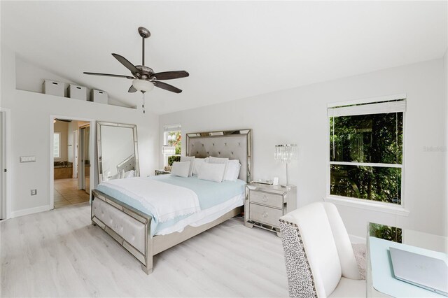 9285 Wickham Way, Orlando, FL 32836 - bedroom with lofted ceiling, light wood-style flooring, ceiling fan, and ensuite bathroom