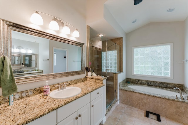 9285 Wickham Way, Orlando, FL 32836 - bathroom with vanity, a garden tub, a shower stall, tile patterned flooring, and vaulted ceiling