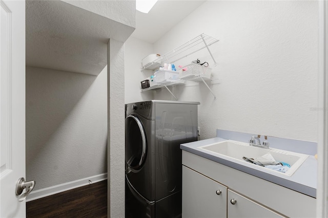 9285 Wickham Way, Orlando, FL 32836 - washroom featuring washer / clothes dryer, dark wood finished floors, cabinet space, and a textured wall