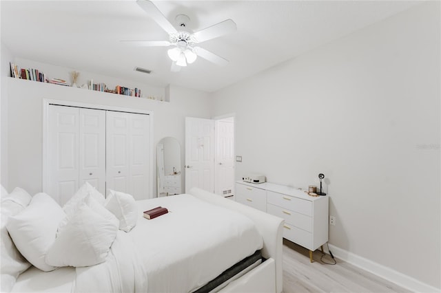 9285 Wickham Way, Orlando, FL 32836 - bedroom with light wood-style flooring, a closet, and a ceiling fan