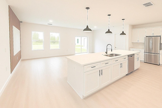 1309 Hillsborough Ln, Kissimmee, FL 34759 - kitchen featuring appliances with stainless steel finishes, light wood-style floors, recessed lighting, light countertops, and white cabinets
