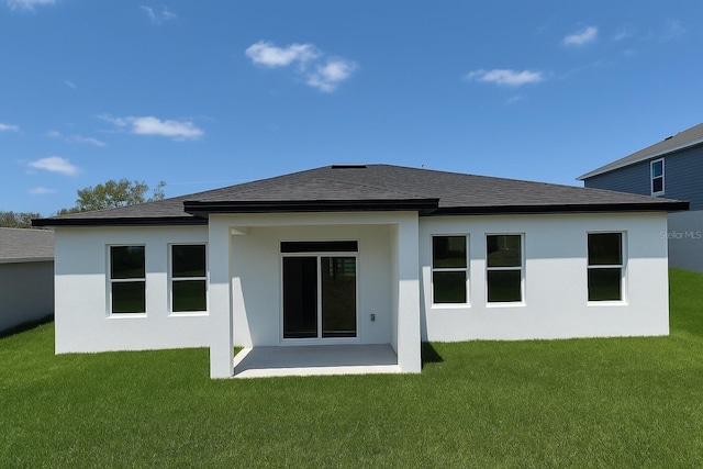1309 Hillsborough Ln, Kissimmee, FL 34759 - rear view of house featuring a yard, stucco siding, and a shingled roof