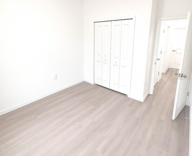 1309 Hillsborough Ln, Kissimmee, FL 34759 - unfurnished bedroom with light wood-style floors and a closet