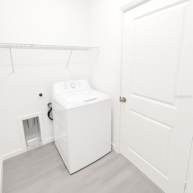1309 Hillsborough Ln, Kissimmee, FL 34759 - laundry area featuring washer / clothes dryer and light wood-type flooring
