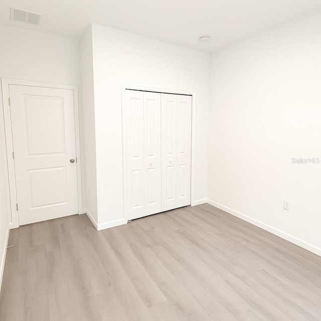 1309 Hillsborough Ln, Kissimmee, FL 34759 - unfurnished bedroom with light wood-type flooring and a closet