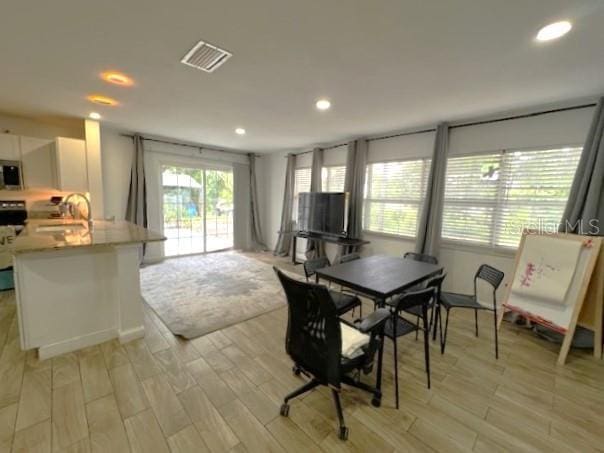 9148 Oakwood Dr, Lake Wales, FL 33898 - dining space with light wood-type flooring and recessed lighting