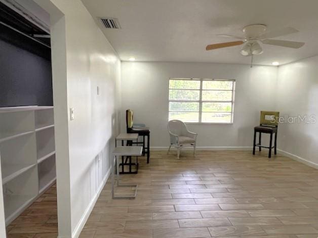 9148 Oakwood Dr, Lake Wales, FL 33898 - sitting room featuring ceiling fan and wood finished floors