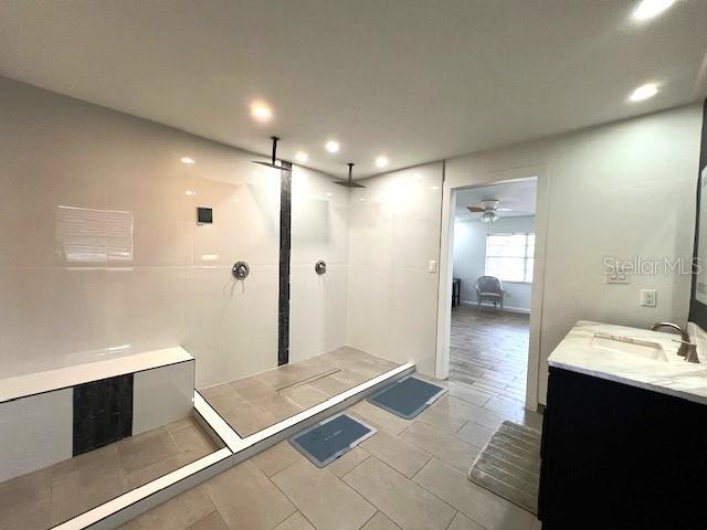 9148 Oakwood Dr, Lake Wales, FL 33898 - bathroom featuring a walk in shower, vanity, recessed lighting, a ceiling fan, and tile patterned floors