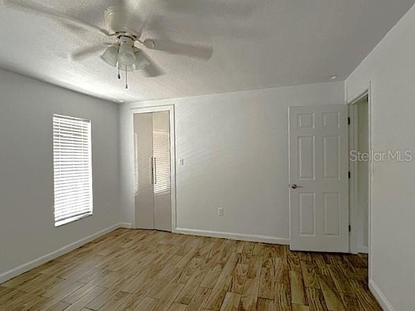 9148 Oakwood Dr, Lake Wales, FL 33898 - unfurnished room featuring wood finished floors and ceiling fan