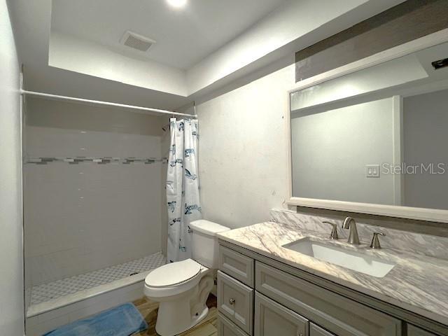 9148 Oakwood Dr, Lake Wales, FL 33898 - bathroom featuring a stall shower, vanity, and a tray ceiling