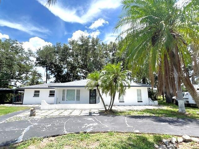 9148 Oakwood Dr, Lake Wales, FL 33898 - view of front facade with stucco siding and asphalt driveway