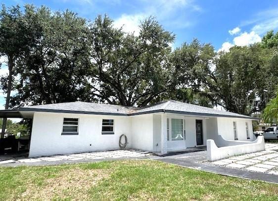 9148 Oakwood Dr, Lake Wales, FL 33898 - rear view of house featuring stucco siding