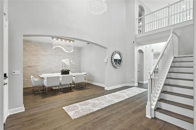 13924 Jomatt Loop, Winter Garden, FL 34787 - entryway with arched walkways, stairs, wood finished floors, a high ceiling, and a chandelier