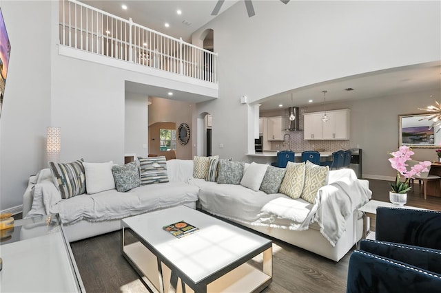 13924 Jomatt Loop, Winter Garden, FL 34787 - living area featuring arched walkways, dark wood finished floors, ceiling fan, a high ceiling, and recessed lighting