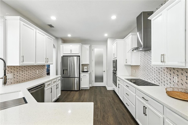 13924 Jomatt Loop, Winter Garden, FL 34787 - kitchen featuring appliances with stainless steel finishes, wall chimney range hood, dark wood-style flooring, backsplash, and white cabinetry