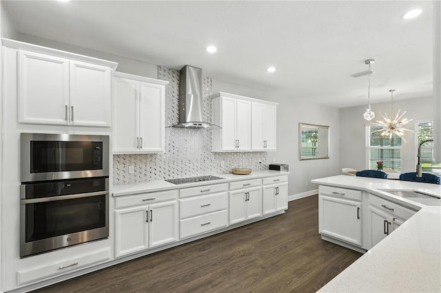 13924 Jomatt Loop, Winter Garden, FL 34787 - kitchen featuring oven, wall chimney exhaust hood, built in microwave, black electric cooktop, and dark wood finished floors