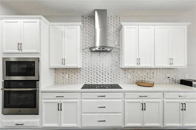 13924 Jomatt Loop, Winter Garden, FL 34787 - kitchen with wall chimney exhaust hood, stainless steel appliances, white cabinetry, light countertops, and decorative backsplash