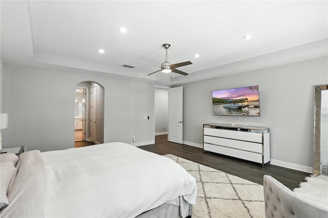13924 Jomatt Loop, Winter Garden, FL 34787 - bedroom featuring arched walkways, wood finished floors, recessed lighting, ceiling fan, and ensuite bath