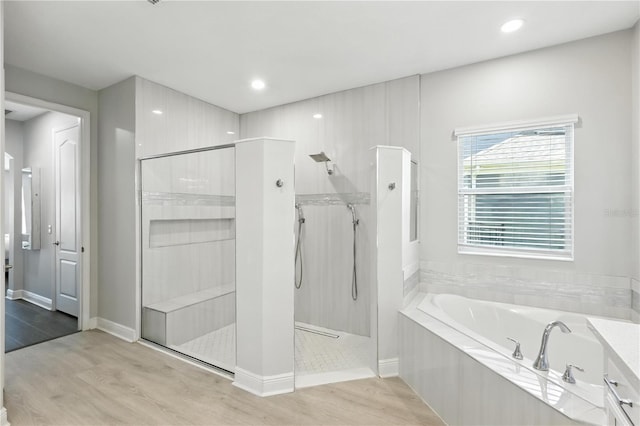 13924 Jomatt Loop, Winter Garden, FL 34787 - bathroom with a garden tub, a walk in shower, wood finished floors, and recessed lighting