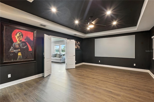 13924 Jomatt Loop, Winter Garden, FL 34787 - home theater with a tray ceiling, wood finished floors, recessed lighting, and a ceiling fan
