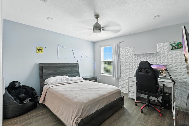 13924 Jomatt Loop, Winter Garden, FL 34787 - bedroom featuring wood finished floors, ceiling fan, a textured ceiling, and a desk