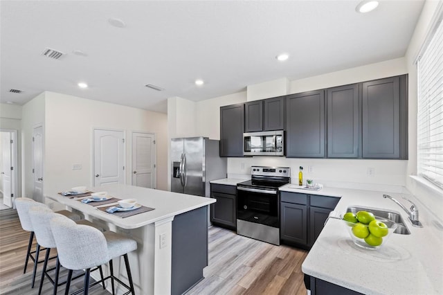 85 Las Casitas Blvd, Palm Coast, FL 32137 - kitchen featuring appliances with stainless steel finishes, a kitchen island, plenty of natural light, light wood-style floors, and recessed lighting