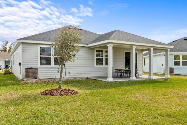 85 Las Casitas Blvd, Palm Coast, FL 32137 - back of house featuring a patio area, a yard, and roof with shingles