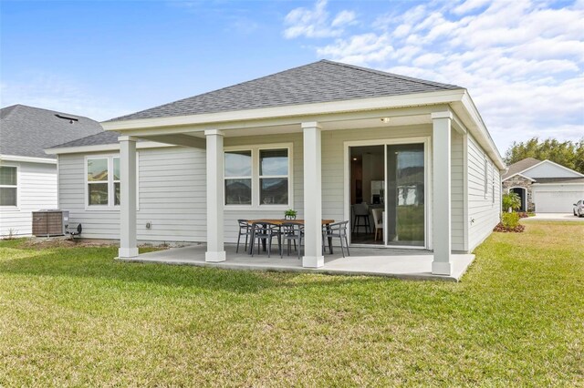 85 Las Casitas Blvd, Palm Coast, FL 32137 - back of house with a yard, a patio, and a shingled roof