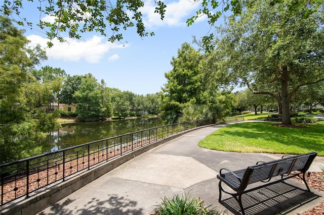 4709 Fox St, Orlando, FL 32814 - view of community featuring a water view, a yard, and view of wooded area