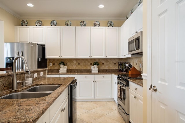 4709 Fox St, Orlando, FL 32814 - kitchen with appliances with stainless steel finishes, white cabinetry, decorative backsplash, dark stone countertops, and crown molding