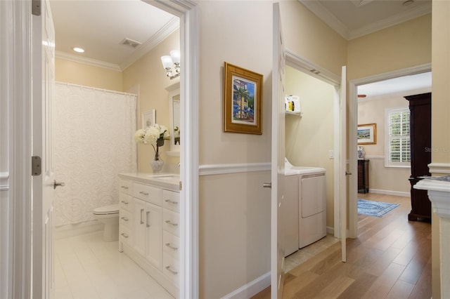 4709 Fox St, Orlando, FL 32814 - bathroom featuring independent washer and dryer, vanity, crown molding, and wood finished floors