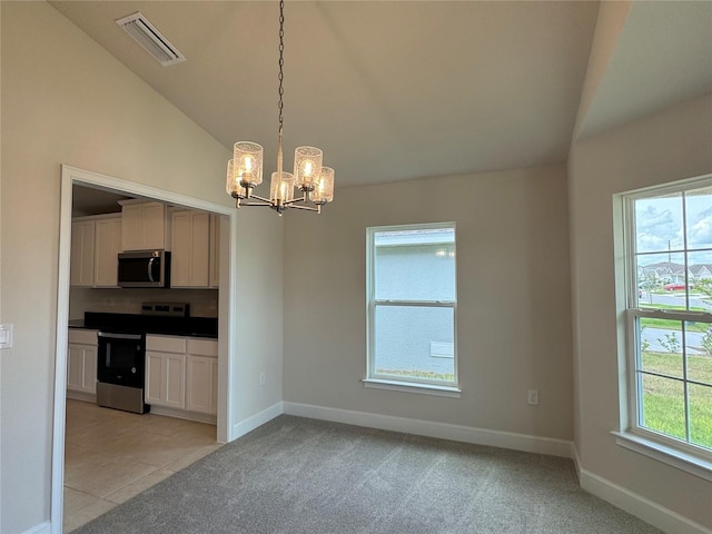 3891 Sagefield Dr, Harmony, FL 34773 - kitchen with appliances with stainless steel finishes, lofted ceiling, a chandelier, light colored carpet, and decorative light fixtures