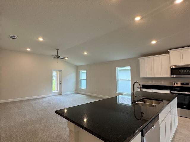 3891 Sagefield Dr, Harmony, FL 34773 - kitchen with appliances with stainless steel finishes, ceiling fan, white cabinets, an island with sink, and recessed lighting